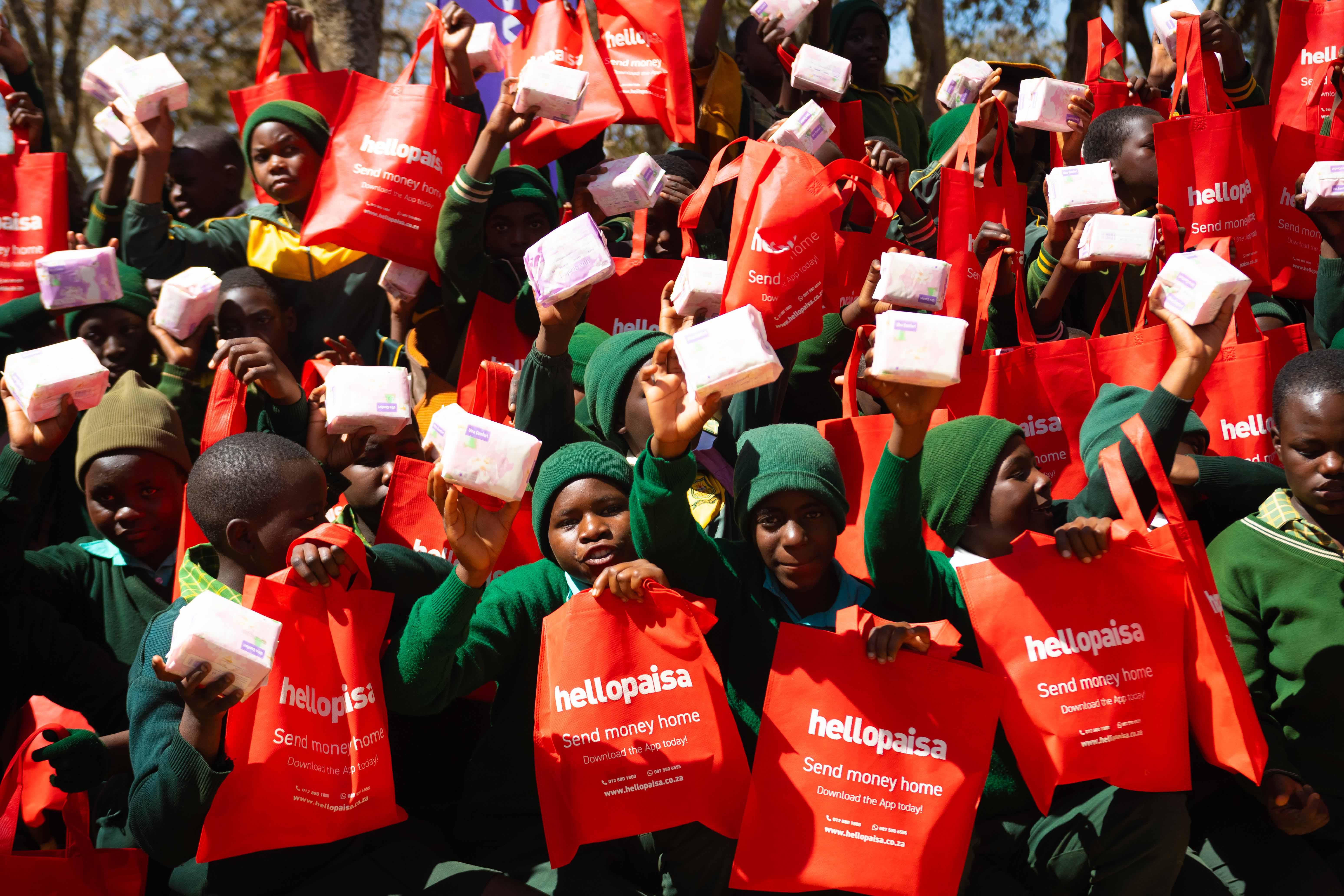 Group of Zimbabwean schoolgirls receiving sanitary pads during HelloPaisa Sanitary Pad Drive
